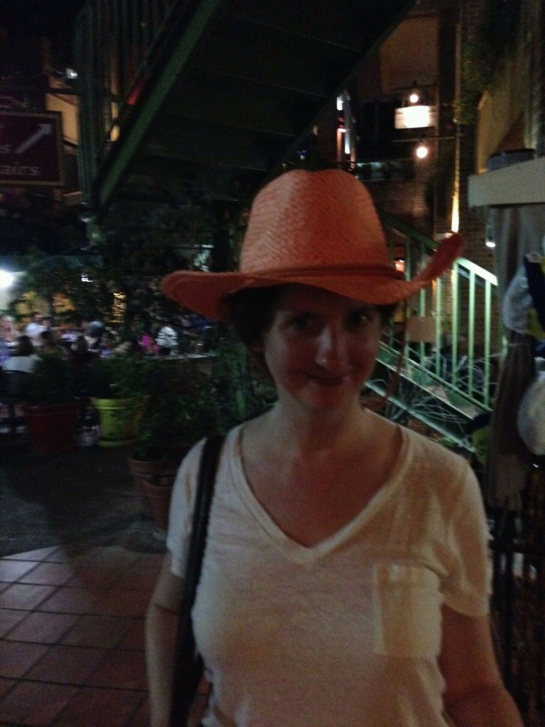 Beth posing in a cowboy hat on the River Walk in San Antonio, TX.  Maybe on our next leg, we'll convince her to buy one. :)